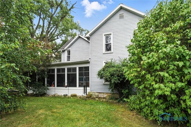 5660 Rd 180, Antwerp, OH 45813 - rear view of house featuring a sunroom and a lawn