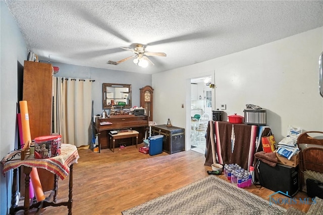 5660 Rd 180, Antwerp, OH 45813 - sitting room featuring wood finished floors, a ceiling fan, and a textured ceiling