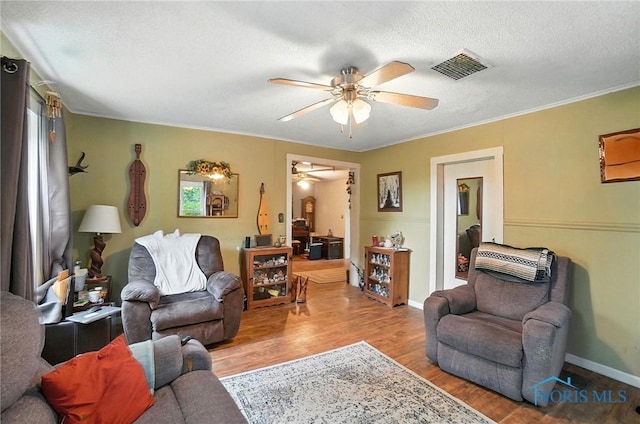 5660 Rd 180, Antwerp, OH 45813 - living room featuring a ceiling fan, wood finished floors, a textured ceiling, and crown molding
