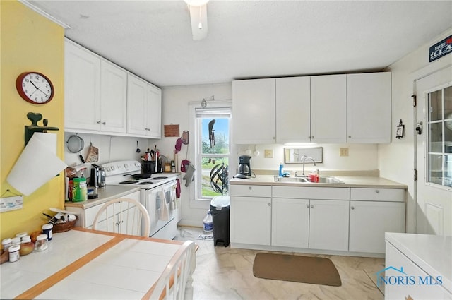 5660 Rd 180, Antwerp, OH 45813 - kitchen with white range with electric cooktop, white cabinets, light countertops, and light marble finish floors