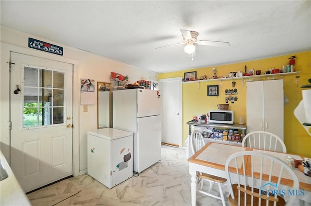 5660 Rd 180, Antwerp, OH 45813 - kitchen featuring light marble finish flooring, ceiling fan, refrigerator, and freestanding refrigerator