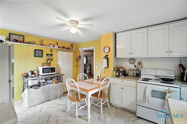 5660 Rd 180, Antwerp, OH 45813 - kitchen with white appliances, light marble finish flooring, a ceiling fan, and white cabinetry