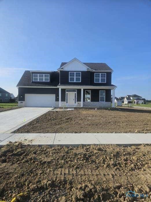 6332 Pimlico Rd, Whitehouse, OH 43571 - traditional-style home featuring a garage, driveway, and a porch