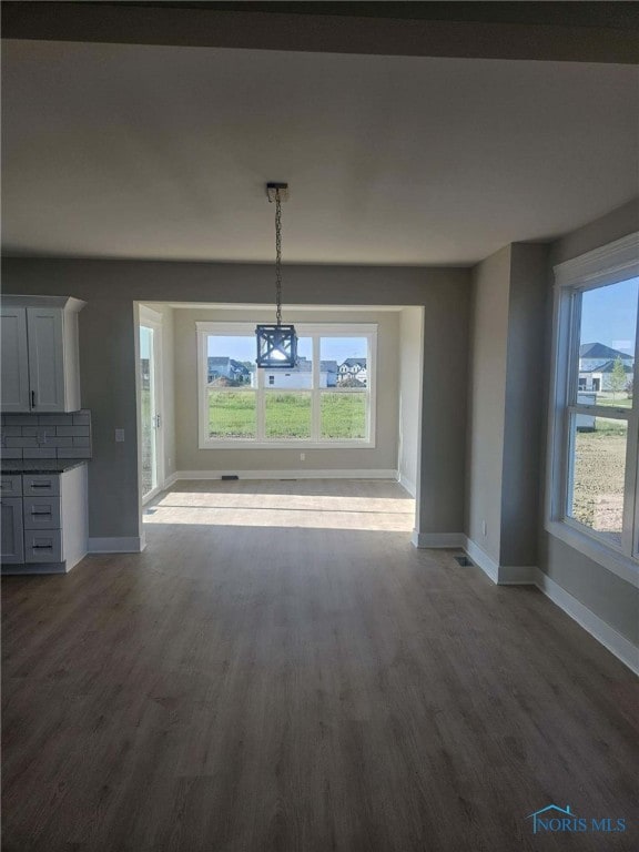 6332 Pimlico Rd, Whitehouse, OH 43571 - unfurnished dining area with dark wood finished floors and baseboards