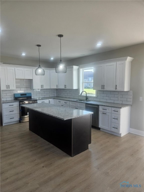 6332 Pimlico Rd, Whitehouse, OH 43571 - kitchen with appliances with stainless steel finishes, tasteful backsplash, a kitchen island, white cabinets, and recessed lighting