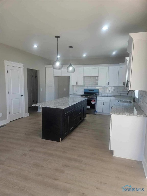 6332 Pimlico Rd, Whitehouse, OH 43571 - kitchen with stainless steel range with electric stovetop, decorative backsplash, light wood-type flooring, white cabinetry, and recessed lighting