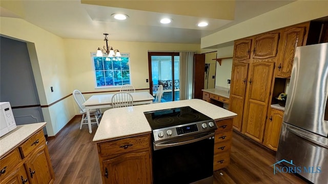 2359 Cheshire Woods Rd, Toledo, OH 43617 - kitchen featuring stainless steel appliances, brown cabinetry, light countertops, dark wood-style flooring, and recessed lighting