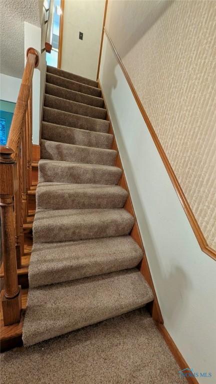 2359 Cheshire Woods Rd, Toledo, OH 43617 - stairs featuring carpet and a textured ceiling