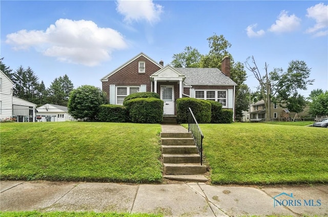 1447 Craigwood Rd, Toledo, OH 43612 - bungalow-style house featuring a chimney, a front lawn, and brick siding