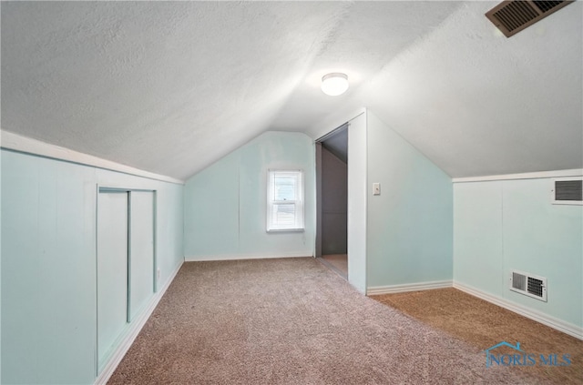 1447 Craigwood Rd, Toledo, OH 43612 - bonus room featuring a textured ceiling, carpet flooring, and vaulted ceiling