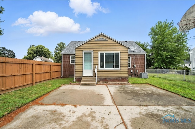 1447 Craigwood Rd, Toledo, OH 43612 - rear view of house with entry steps, a patio area, a fenced backyard, a shingled roof, and brick siding
