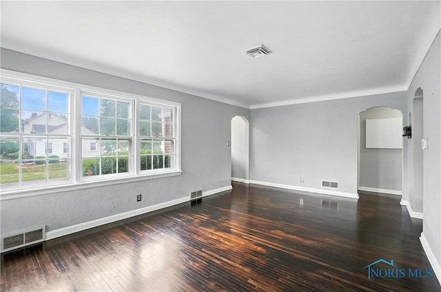 1447 Craigwood Rd, Toledo, OH 43612 - spare room with arched walkways and hardwood / wood-style flooring