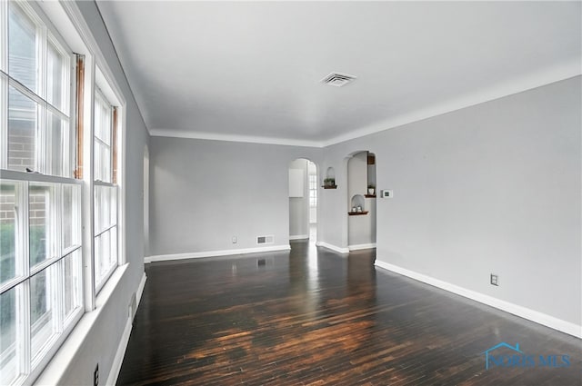1447 Craigwood Rd, Toledo, OH 43612 - spare room with arched walkways, plenty of natural light, and hardwood / wood-style floors