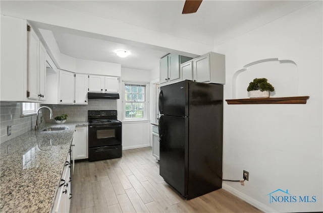 1447 Craigwood Rd, Toledo, OH 43612 - kitchen with black appliances, light stone counters, decorative backsplash, white cabinetry, and light wood-type flooring