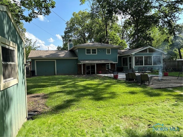 2920 Copland Blvd, Toledo, OH 43614 - rear view of property with a garage, a chimney, a sunroom, and a patio area