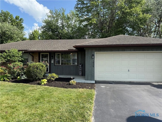 1819 Queenswood Dr, Findlay, OH 45840 - ranch-style home featuring roof with shingles, driveway, a front yard, and a garage