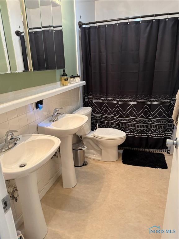 1819 Queenswood Dr, Findlay, OH 45840 - bathroom with tile walls and a shower with curtain