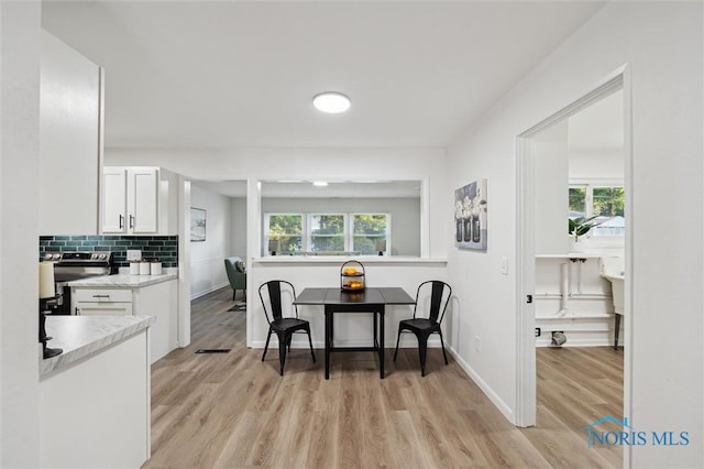 3129 Elmview Dr, Toledo, OH 43613 - dining room with light wood-style floors and baseboards