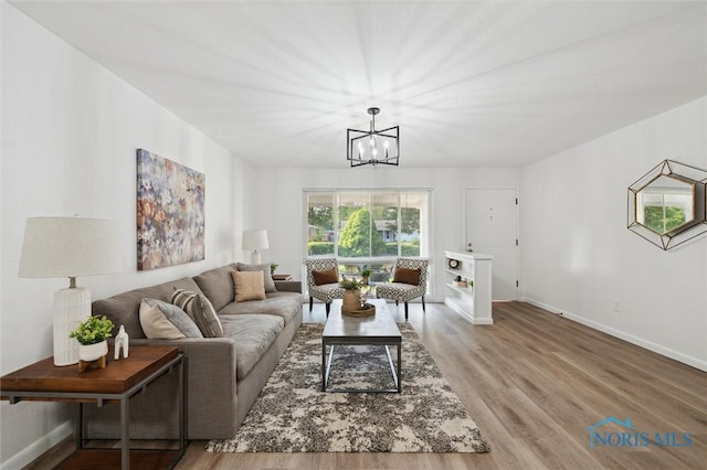 3129 Elmview Dr, Toledo, OH 43613 - living room featuring a chandelier and light wood-style floors