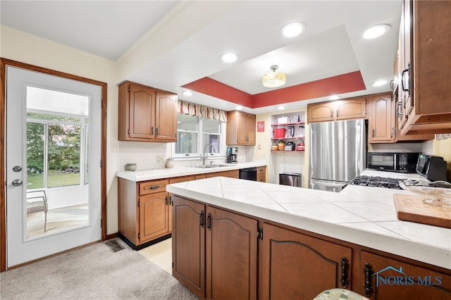 229 Hawthorn Dr, Archbold, OH 43502 - kitchen with black appliances, a peninsula, light colored carpet, brown cabinets, and open shelves