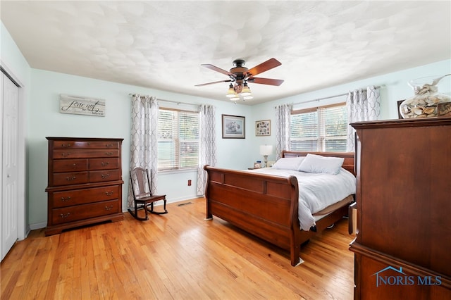 229 Hawthorn Dr, Archbold, OH 43502 - bedroom with light wood-style floors, a closet, and a ceiling fan