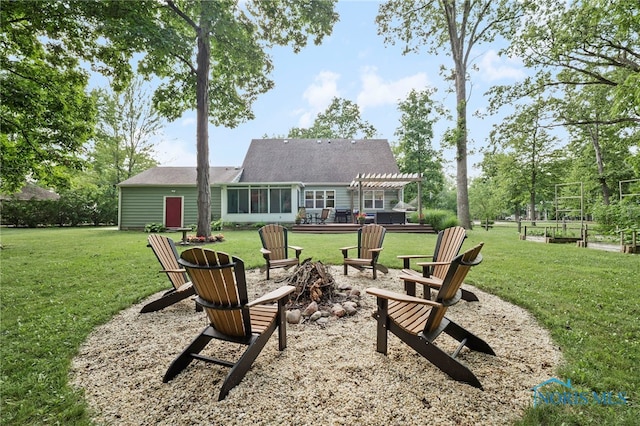 229 Hawthorn Dr, Archbold, OH 43502 - back of property featuring a fire pit, a pergola, and a lawn