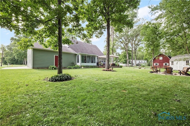 229 Hawthorn Dr, Archbold, OH 43502 - view of grassy yard with a storage shed