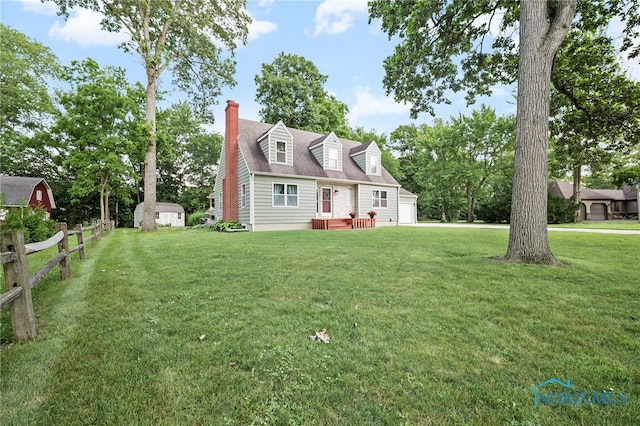 229 Hawthorn Dr, Archbold, OH 43502 - new england style home featuring a chimney and a storage unit