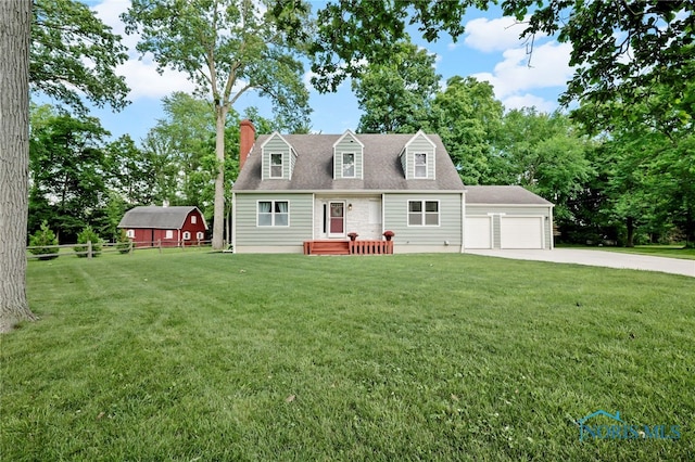 229 Hawthorn Dr, Archbold, OH 43502 - new england style home with a garage, concrete driveway, a chimney, an outdoor structure, and a barn