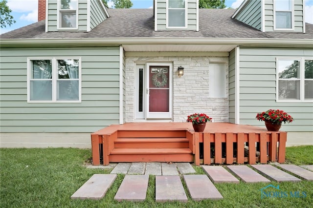 229 Hawthorn Dr, Archbold, OH 43502 - entrance to property featuring a shingled roof, a lawn, and stone siding