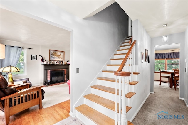 229 Hawthorn Dr, Archbold, OH 43502 - staircase with plenty of natural light, a brick fireplace, and carpet flooring
