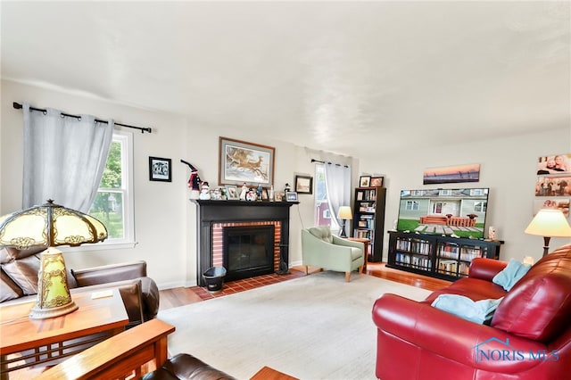 229 Hawthorn Dr, Archbold, OH 43502 - living area with a brick fireplace and wood finished floors