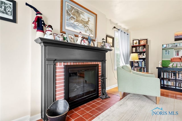 229 Hawthorn Dr, Archbold, OH 43502 - tiled living area with a fireplace and baseboards
