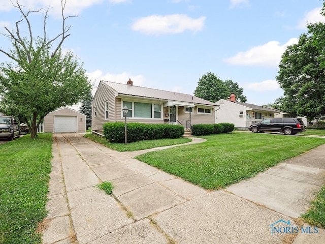 1242 Holgate Ave, Maumee, OH 43537 - view of front of house with a garage, driveway, an outdoor structure, a front yard, and a chimney