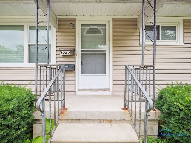 1242 Holgate Ave, Maumee, OH 43537 - view of exterior entry with a porch