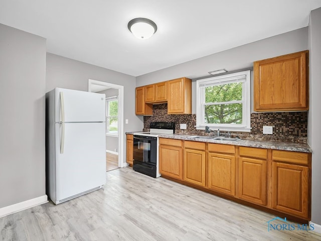 1242 Holgate Ave, Maumee, OH 43537 - kitchen featuring freestanding refrigerator, black / electric stove, light wood-type flooring, and decorative backsplash