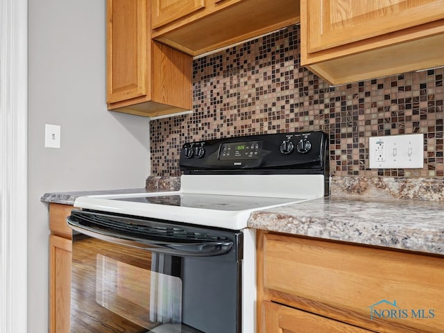 1242 Holgate Ave, Maumee, OH 43537 - kitchen featuring black electric range and backsplash