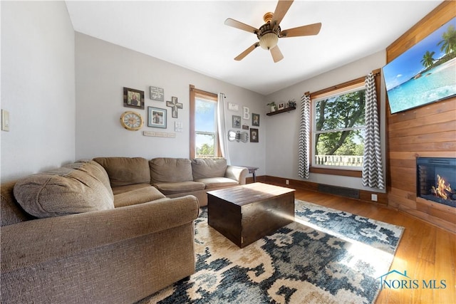 22804 State Route 2, Archbold, OH 43502 - living area with wood finished floors, ceiling fan, and a glass covered fireplace