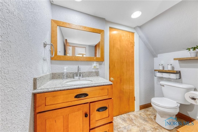 22804 State Route 2, Archbold, OH 43502 - bathroom with a textured wall, vaulted ceiling, and vanity