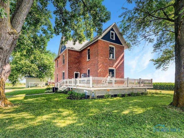 22804 State Route 2, Archbold, OH 43502 - back of property with brick siding, a yard, and a wooden deck