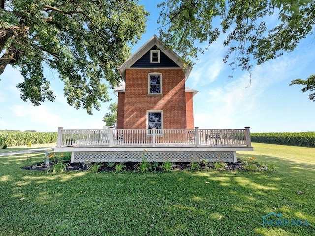 22804 State Route 2, Archbold, OH 43502 - rear view of house featuring a wooden deck, a lawn, and brick siding