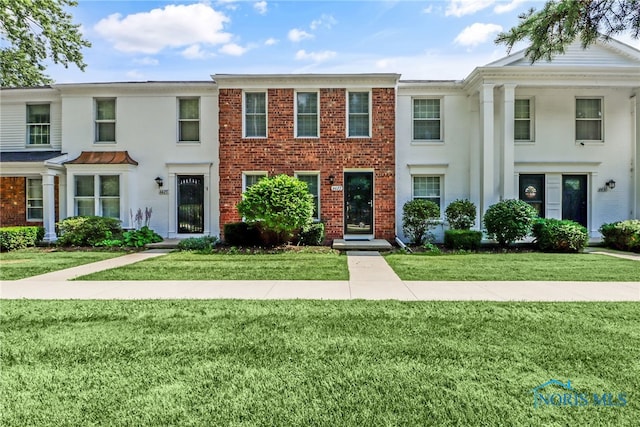 6627 Garden Rd Unit 6627, Maumee, OH 43537 - view of front facade featuring a front yard and brick siding