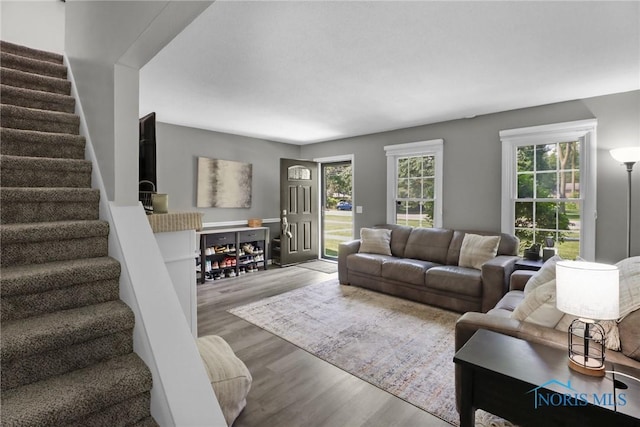 6627 Garden Rd Unit 6627, Maumee, OH 43537 - living area with stairs, wood finished floors, and healthy amount of natural light