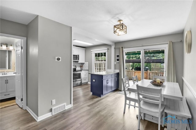 6627 Garden Rd Unit 6627, Maumee, OH 43537 - dining room with light wood finished floors and baseboards