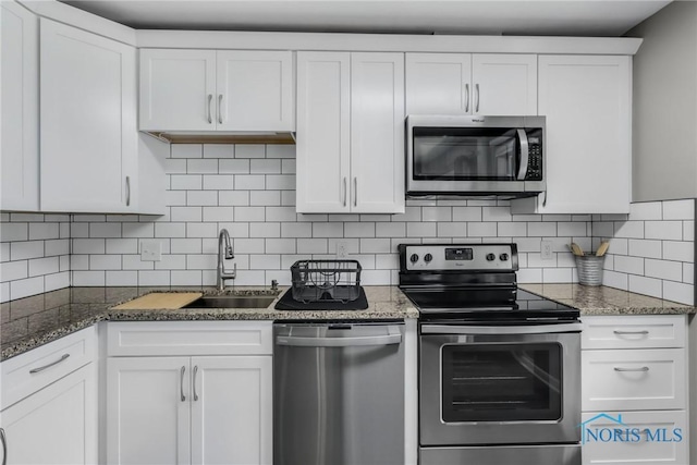 6627 Garden Rd Unit 6627, Maumee, OH 43537 - kitchen featuring appliances with stainless steel finishes, white cabinets, decorative backsplash, and stone countertops