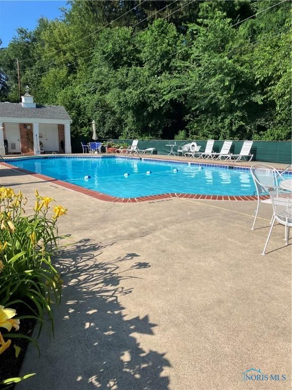 5679 Monroe St Unit 207, Sylvania, OH 43560 - community pool with a patio and an outbuilding