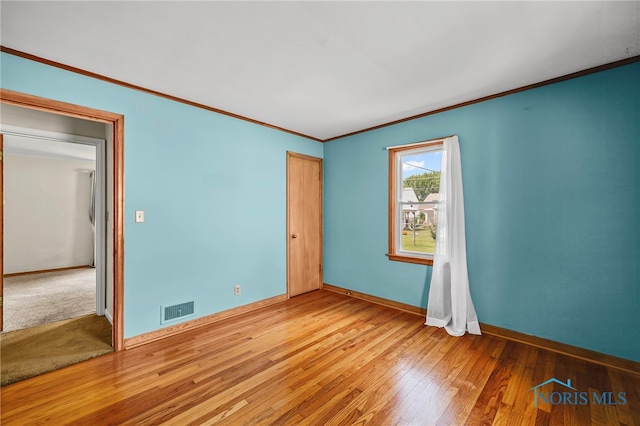 212 18th St, Findlay, OH 45840 - unfurnished bedroom with hardwood / wood-style flooring and crown molding