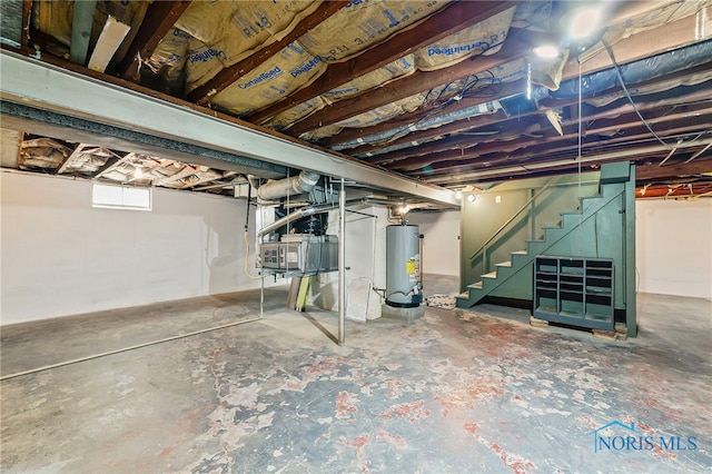 212 18th St, Findlay, OH 45840 - below grade area featuring gas water heater and stairway