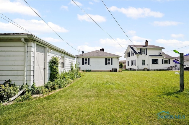 212 18th St, Findlay, OH 45840 - rear view of house featuring a lawn