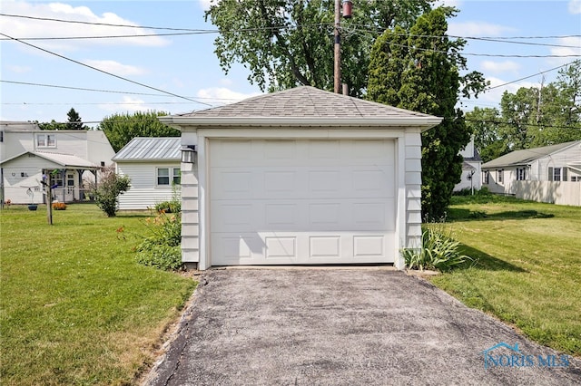 212 18th St, Findlay, OH 45840 - detached garage featuring asphalt driveway